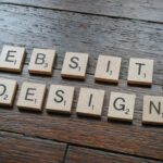 Brown wooden table with the words “Website Design” displayed, representing choosing the right website design for a church.